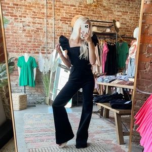 Flying pepper stretch denim jumpsuit ruffled sleeves side cut-outs back zipper.